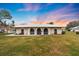 Tan single story home with a gently sloping lawn at 430 Botticelli Dr # 430, Nokomis, FL 34275