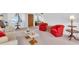Living room with red armchairs and beige sofa at 430 Botticelli Dr # 430, Nokomis, FL 34275