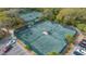 Two well-maintained tennis courts with seating at 4842 Greywood Ln, Sarasota, FL 34235