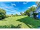 Spacious grassy backyard with ocean view, lush landscaping, and privacy at 506 S Casey Key Rd, Nokomis, FL 34275