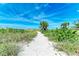 Sandy beach access path through dunes and vegetation at 506 S Casey Key Rd, Nokomis, FL 34275