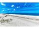 White sand beach with calm ocean and blue sky at 506 S Casey Key Rd, Nokomis, FL 34275