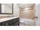 Bathroom with dark vanity, tub, and tile shower surround at 5218 Wedgewood Ln # 72, Sarasota, FL 34235