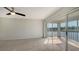 Bedroom with carpet, ceiling fan and access to balcony at 5218 Wedgewood Ln # 72, Sarasota, FL 34235