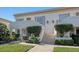 Attractive building entrance with landscaping and stairs at 5218 Wedgewood Ln # 72, Sarasota, FL 34235