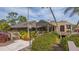 Landscaped clubhouse exterior with walkway at 5218 Wedgewood Ln # 72, Sarasota, FL 34235