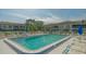 Refreshing community pool with lounge chairs and umbrellas at 5218 Wedgewood Ln # 72, Sarasota, FL 34235
