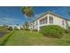 Condo building with lush landscaping and canal views at 5218 Wedgewood Ln # 72, Sarasota, FL 34235