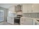 Modern kitchen with white cabinets, stainless steel appliances and tile backsplash at 5218 Wedgewood Ln # 72, Sarasota, FL 34235