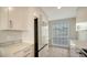 Modern white kitchen with stainless steel appliances and quartz countertops at 5218 Wedgewood Ln # 72, Sarasota, FL 34235