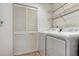Laundry room with washer, dryer, shelving, and louvered door at 5218 Wedgewood Ln # 72, Sarasota, FL 34235