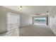 Bright living room with carpeting and sliding doors to balcony at 5218 Wedgewood Ln # 72, Sarasota, FL 34235