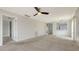 Spacious living room with neutral walls and carpet, and access to hallway at 5218 Wedgewood Ln # 72, Sarasota, FL 34235