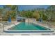Inviting community pool with lounge chairs and umbrellas at 5218 Wedgewood Ln # 72, Sarasota, FL 34235