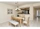 Bright dining room with a wood table and bench seating, adjacent to kitchen at 5330 Hyland Hills Ave # 2311, Sarasota, FL 34241