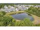 Aerial view of community with pond and homes at 5809 Leopardstown Dr, Tampa, FL 33610