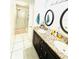 Bathroom with a double vanity, shower and tile floors at 5809 Leopardstown Dr, Tampa, FL 33610