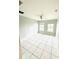 Bright bedroom with tile flooring and two large windows at 5809 Leopardstown Dr, Tampa, FL 33610