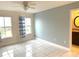 Bright bedroom with tile floors, ceiling fan, and large windows at 5809 Leopardstown Dr, Tampa, FL 33610