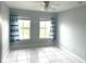 Bedroom with water view, tile floors, and ceiling fan at 5809 Leopardstown Dr, Tampa, FL 33610