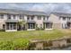 Back exterior view with screened porch and pond view at 5809 Leopardstown Dr, Tampa, FL 33610