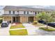 Tan townhouses with attached garages and landscaped yards at 5809 Leopardstown Dr, Tampa, FL 33610