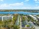 Aerial perspective highlighting the property's position near a waterway and other buildings at 5955 Midnight Pass Rd # 4E, Sarasota, FL 34242