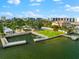 Aerial view of waterfront property with a grassy area, pool, and private docks at 5955 Midnight Pass Rd # 4E, Sarasota, FL 34242