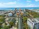 Aerial view of the property and its surroundings, including the ocean in the distance at 5955 Midnight Pass Rd # 4E, Sarasota, FL 34242
