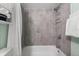 Clean bathroom with shower/tub combo and gray tile at 5955 Midnight Pass Rd # 4E, Sarasota, FL 34242