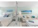 Bright bedroom with a queen bed, white dresser, and beach-themed decor at 5955 Midnight Pass Rd # 4E, Sarasota, FL 34242