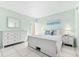 Bedroom with white dresser and a queen-size bed, beach decor at 5955 Midnight Pass Rd # 4E, Sarasota, FL 34242