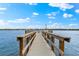 Wooden fishing pier extending over the water; perfect for a relaxing day at 5955 Midnight Pass Rd # 4E, Sarasota, FL 34242