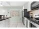 Kitchen with stainless steel appliances and white shaker cabinets at 5955 Midnight Pass Rd # 4E, Sarasota, FL 34242