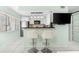 Open kitchen boasts stainless steel appliances and breakfast bar at 5955 Midnight Pass Rd # 4E, Sarasota, FL 34242