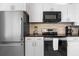 Modern kitchen features stainless steel appliances and granite countertops at 5955 Midnight Pass Rd # 4E, Sarasota, FL 34242