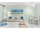 Coastal-themed living room with white furniture and beach art at 5955 Midnight Pass Rd # 4E, Sarasota, FL 34242