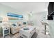 Coastal living room with a sofa, coffee table and dining area at 5955 Midnight Pass Rd # 4E, Sarasota, FL 34242