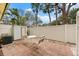 Private patio area with small table and chairs, next to a storage shed at 5955 Midnight Pass Rd # 4E, Sarasota, FL 34242