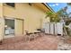 Private patio with table and chairs, adjacent to storage shed at 5955 Midnight Pass Rd # 4E, Sarasota, FL 34242