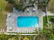 Inviting community pool with surrounding patio furniture and lush landscaping at 5955 Midnight Pass Rd # 4E, Sarasota, FL 34242