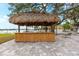 Thatch-roof tiki bar with bamboo counter; ideal for casual gatherings at 5955 Midnight Pass Rd # 4E, Sarasota, FL 34242