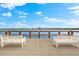Elevated wooden deck with benches overlooking the water at 5955 Midnight Pass Rd # 4E, Sarasota, FL 34242