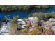 Aerial view of waterfront home with lush landscaping and canal access at 8440 Midnight Pass Rd, Sarasota, FL 34242