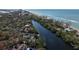 Aerial view of waterfront home showcasing canal location near beach at 8440 Midnight Pass Rd, Sarasota, FL 34242