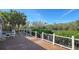 Deck overlooking waterway with table and chairs at 8440 Midnight Pass Rd, Sarasota, FL 34242