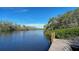 Wooden dock on calm waterway, surrounded by trees at 8440 Midnight Pass Rd, Sarasota, FL 34242