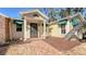 Cute yellow house with a charming front porch and brick walkway at 8440 Midnight Pass Rd, Sarasota, FL 34242