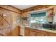 Charming kitchen with wood cabinets, double sink, and electric stove at 8440 Midnight Pass Rd, Sarasota, FL 34242