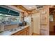 Rustic kitchen features wood cabinets, a double sink, and microwave at 8440 Midnight Pass Rd, Sarasota, FL 34242